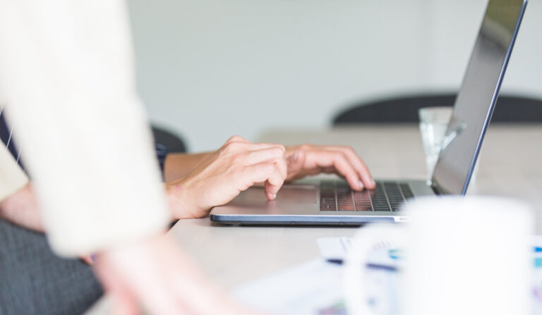 Hands using computer in office