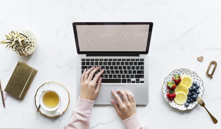 Laptop at the table with tea at side