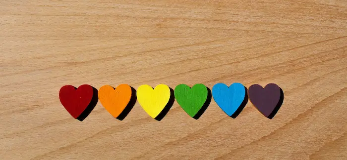 rainbow-wooden-hearts-lined-up-on-oak-table