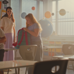 Students packing belongings in classroom