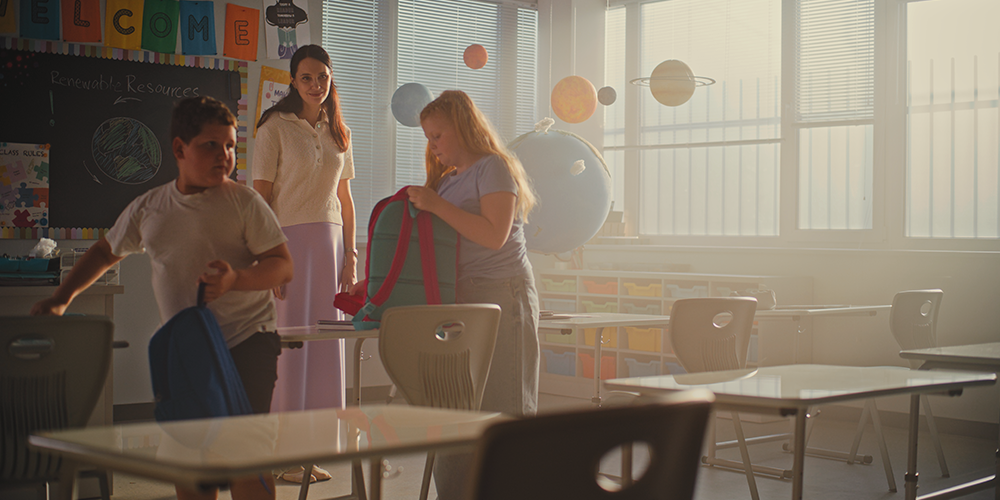 Students packing belongings in classroom