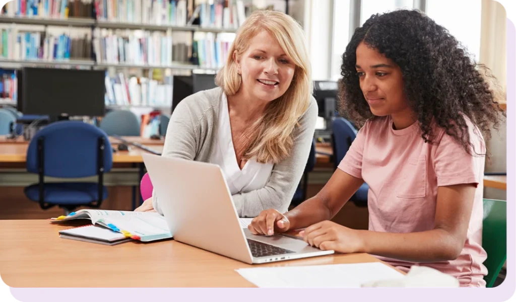 Teacher helping student on the computer